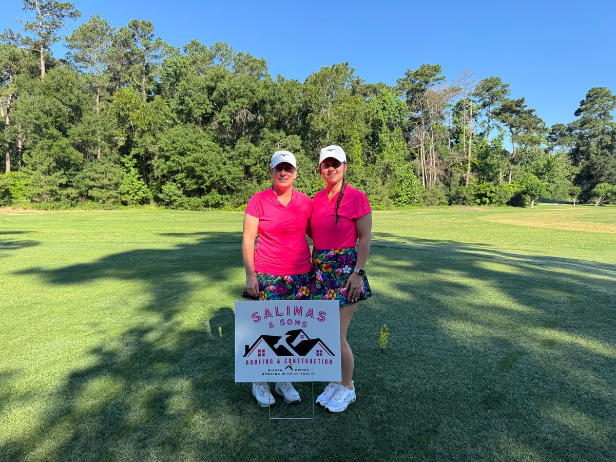 Jess Salinas and a fellow golfer beside a Salinas and Sons sign at the Augusta Pines tournament