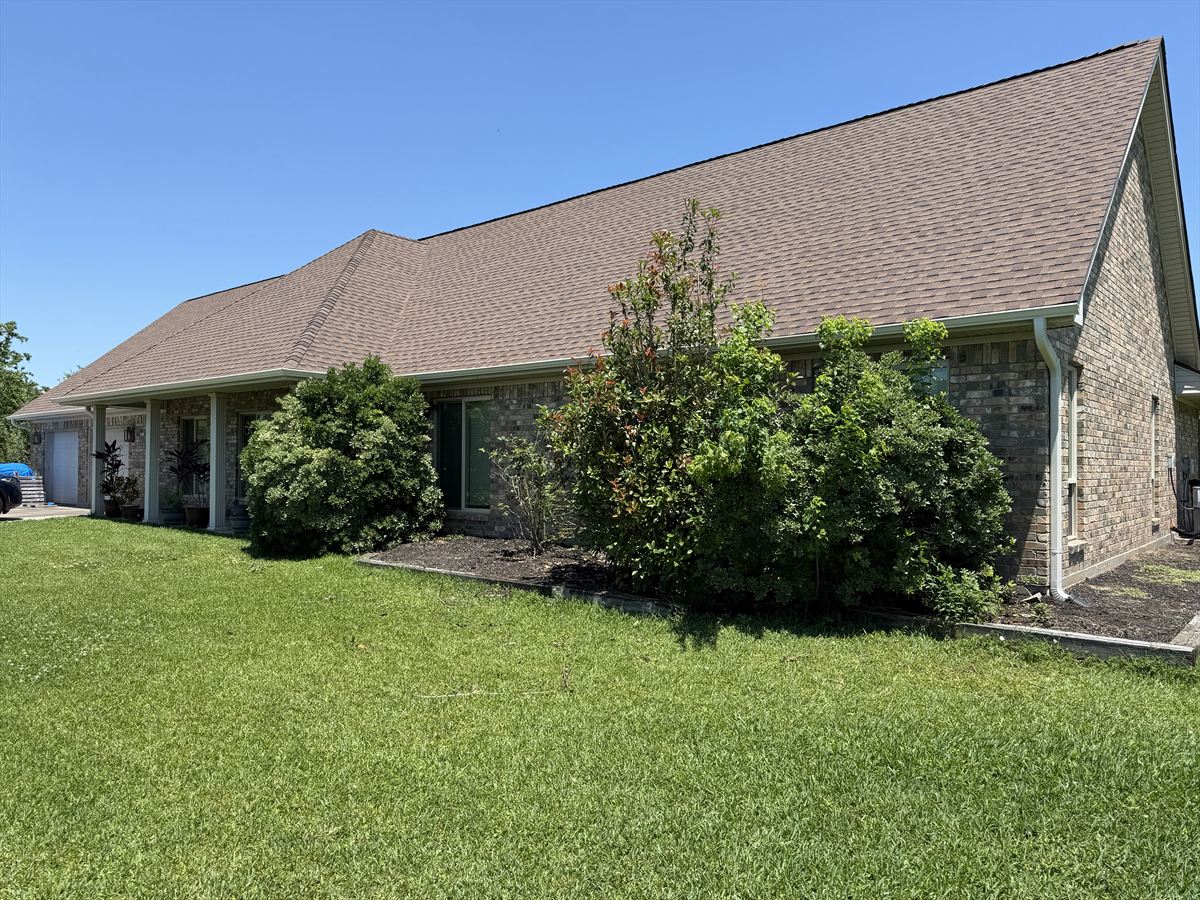 Single-story brick home with its newly replaced architectural shingle roof