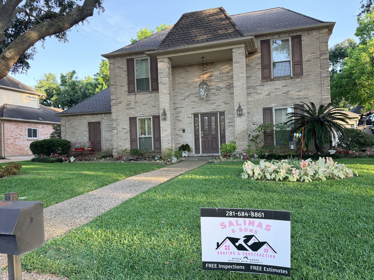 Two-story brick home after a full roof replacement