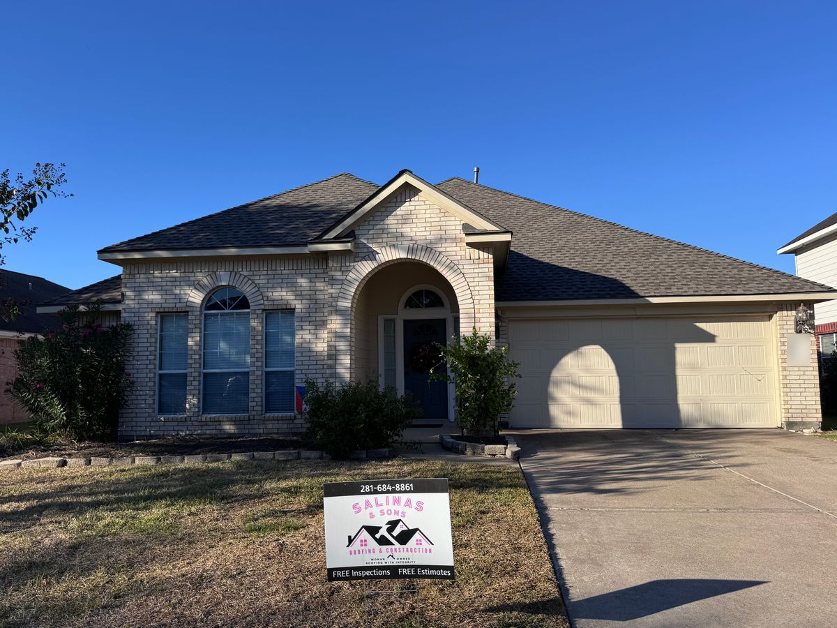 After: same Pearland home with a new Weathered Wood Timberline HDZ roof