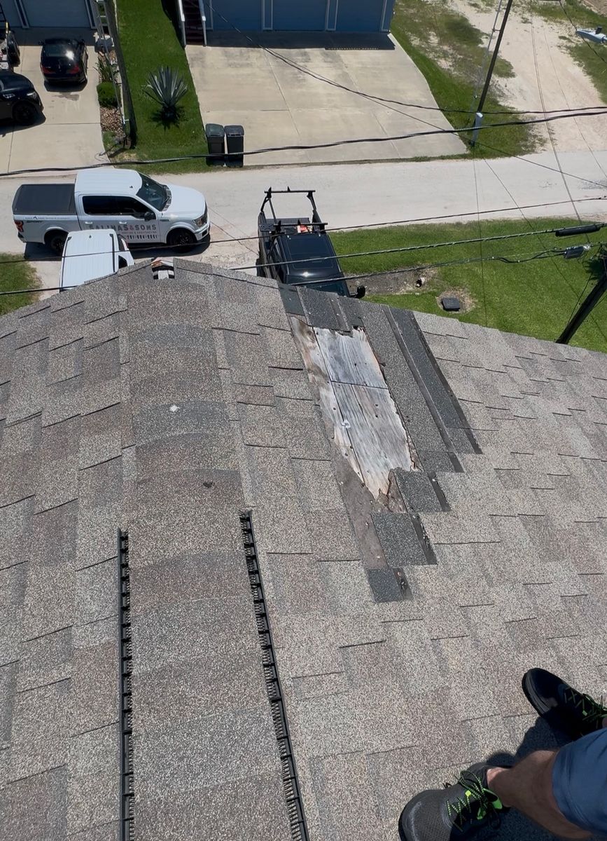 Before: damaged shingles along the ridge of a bayfront roof in San Leon