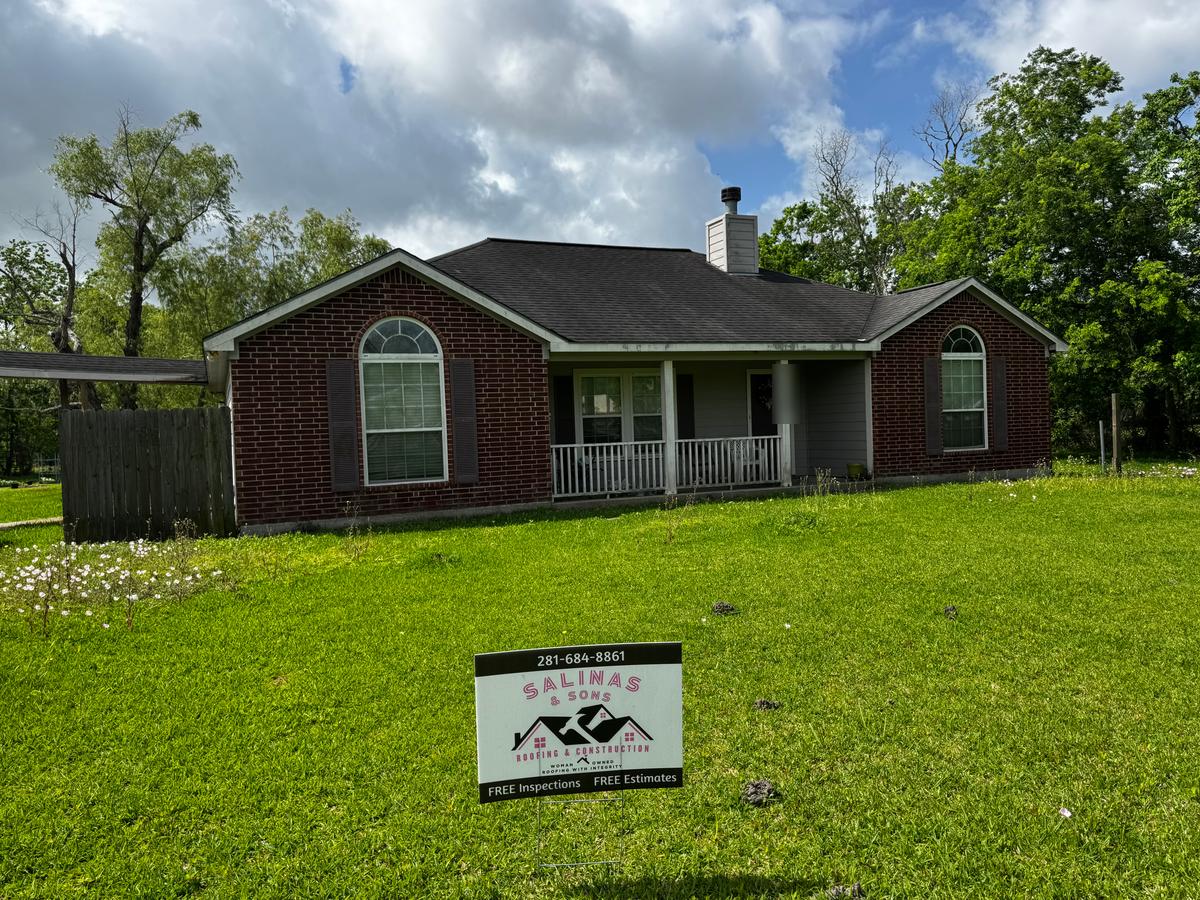 Before: brick ranch home in Santa Fe with a worn gray roof